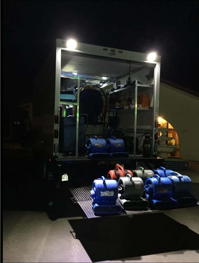 Truck-mounted unit and air movers on a liftgate at night